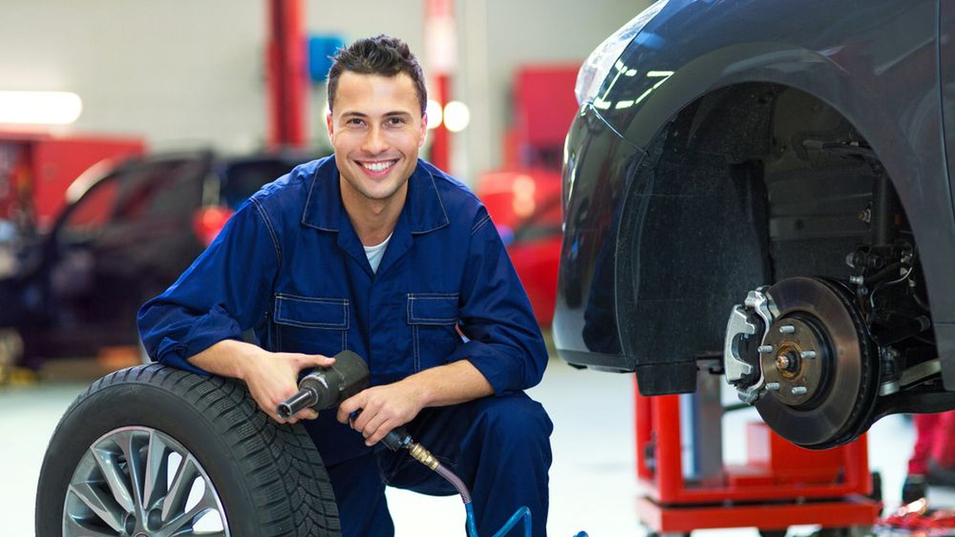 Auto Repair and Service Apprenticeship Shortage - Car Mechanic Fixing Wheels